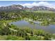 Breathtaking aerial view of a serene lake with walking paths, nestled in a lush green neighborhood and majestic mountain scenery at 1270 Berea Dr, Boulder, CO 80305
