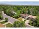 An aerial view of a home nestled among lush trees in a quiet neighborhood on a bright, sunny day at 1270 Berea Dr, Boulder, CO 80305