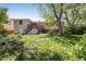 The home features a sprawling backyard with lush greenery and a wooden deck, ideal for relaxation and entertaining at 1270 Berea Dr, Boulder, CO 80305