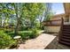 Backyard featuring a brick patio, lush greenery, and trees at 1270 Berea Dr, Boulder, CO 80305