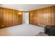 Finished basement with carpet, wood paneling, and an adjoining room at 1270 Berea Dr, Boulder, CO 80305