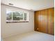 Bright bedroom with a large window with mountain views and wood paneling at 1270 Berea Dr, Boulder, CO 80305