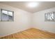 Bright bedroom with hardwood floors, two windows, and neutral walls at 1270 Berea Dr, Boulder, CO 80305