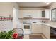 Cozy kitchen with white cabinets, a patterned border, and cheerful decor at 1270 Berea Dr, Boulder, CO 80305