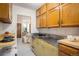 Kitchen featuring wooden cabinets and retro yellow cabinets with a bar space looking into the bedroom at 1270 Berea Dr, Boulder, CO 80305