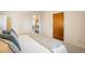 Light filled bedroom with hardwood door and passthrough to kitchen at 1270 Berea Dr, Boulder, CO 80305