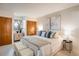 Comfortable bedroom with neutral tones, wood closets, and two pieces of contemporary art above the bed at 1270 Berea Dr, Boulder, CO 80305