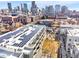 Stunning aerial view showcasing a modern community with solar panels and lush landscaping, set against a city skyline at 2530 Lawrence St # Ra101, Denver, CO 80205