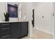 Modern powder room featuring a sleek vanity, unique wallpaper, and contemporary fixtures at 2530 Lawrence St # Ra101, Denver, CO 80205