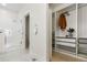 Bright bathroom featuring a glass-enclosed shower, marble floors, and an organized walk-in closet with white shelving at 2530 Lawrence St # Ra101, Denver, CO 80205