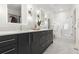 Luxurious bathroom with double vanity, modern mirrors, and a glass-enclosed shower at 2530 Lawrence St # Ra101, Denver, CO 80205
