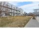 Modern building with balconies and a common area with seating and a playground set in the yard at 2530 Lawrence St # Ra101, Denver, CO 80205