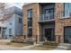 Modern brick townhome with metal accents and a balcony, offering stylish urban living in a well-maintained community at 2530 Lawrence St # Ra101, Denver, CO 80205