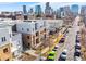 Modern townhome exterior with brick facade and metal accents against a Denver skyline backdrop at 2530 Lawrence St # Ra101, Denver, CO 80205