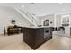 Open-concept kitchen island featuring built-in microwave and drawers with adjacent dining and living areas at 2530 Lawrence St # Ra101, Denver, CO 80205