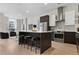 Well-appointed kitchen with stainless steel appliances, a central island, and a view to the living area at 2530 Lawrence St # Ra101, Denver, CO 80205