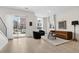 Bright living room with a sliding glass door leading to an outdoor balcony, offering natural light at 2530 Lawrence St # Ra101, Denver, CO 80205