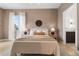 Comfortable bedroom with natural light, soft decor, and an ensuite bathroom at 2530 Lawrence St # Ra101, Denver, CO 80205