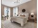 Cozy main bedroom with ample natural light, features neutral tones and a modern chandelier, creating a peaceful retreat at 2530 Lawrence St # Ra101, Denver, CO 80205