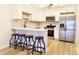 A view of a kitchen featuring stainless steel appliances, white cabinets and a peninsula at 6960 E Girard Ave # 404, Denver, CO 80224