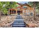Exterior view of a home with a patio, beautiful landscaping, and stone steps leading to the backyard at 5449 Songbird Way, Parker, CO 80134