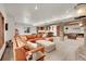 Spacious basement with stone archway, a game room, and a comfortable leather sectional sofa at 5449 Songbird Way, Parker, CO 80134