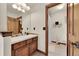 Cozy bathroom features a wooden vanity, tile floors, and a separated toilet and shower area at 5449 Songbird Way, Parker, CO 80134