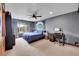 Comfortable bedroom with a baseball theme featuring a large bed, ceiling fan and ample natural light at 5449 Songbird Way, Parker, CO 80134