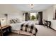 Cozy bedroom with a soft color palette, patterned carpet, and a large window view at 5449 Songbird Way, Parker, CO 80134