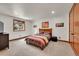 Bright bedroom with a wooden bed frame, large windows, and neutral-colored walls at 5449 Songbird Way, Parker, CO 80134