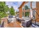 Spacious deck with outdoor furniture, a grill, and views of the surrounding forest at 5449 Songbird Way, Parker, CO 80134