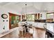 Dining area with wood floors, decorative chandelier and views to the deck and yard at 5449 Songbird Way, Parker, CO 80134