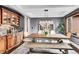 Elegant dining room with wooden table, decorative lighting, and built-in cabinets at 5449 Songbird Way, Parker, CO 80134