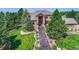 Beautiful two-story home showcasing a sprawling manicured lawn and a lengthy walkway to the front door at 5449 Songbird Way, Parker, CO 80134