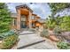 Stunning home showcasing a stone facade, covered entryway, and professionally landscaped front yard at 5449 Songbird Way, Parker, CO 80134