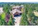 Beautiful home with a three-car garage, mature trees, and manicured landscaping at 5449 Songbird Way, Parker, CO 80134