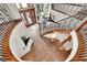 Grand foyer with a winding staircase, detailed ironwork, wood floors, and decorative front doors at 5449 Songbird Way, Parker, CO 80134