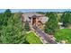 Beautiful home with stone and siding, landscaped front yard, and covered front porch at 5449 Songbird Way, Parker, CO 80134