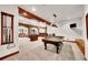 Spacious game room with pool table, foosball table, and a bar for entertaining at 5449 Songbird Way, Parker, CO 80134