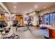 Spacious home gym features weights, fitness machines, and mirrored wall for workout enthusiasts at 5449 Songbird Way, Parker, CO 80134