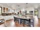 Bright kitchen with white cabinets, a dark marbled island with barstool seating, and stainless steel appliances at 5449 Songbird Way, Parker, CO 80134