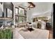 Bright living room with high ceilings, fireplace, large windows and views to the kitchen at 5449 Songbird Way, Parker, CO 80134