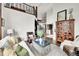 Elegant living room featuring high ceilings, a wrought iron balcony, and stylish decor at 5449 Songbird Way, Parker, CO 80134