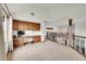 Spacious loft with built-in desk, cabinets, large window, and railing overlooking the lower level at 5449 Songbird Way, Parker, CO 80134
