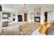 Bright main bedroom with a stone fireplace, plush carpet, a seating area, and outdoor access at 5449 Songbird Way, Parker, CO 80134