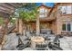 Outdoor entertainment space with a fire pit, seating area, and a partially covered patio at 5449 Songbird Way, Parker, CO 80134