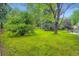 Spacious backyard with lush green lawn and mature trees, offering privacy and a natural setting at 1715 Alkire St, Golden, CO 80401
