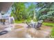 Relaxing backyard with mature trees, a patio, and an outdoor seating area for enjoying the outdoors at 1715 Alkire St, Golden, CO 80401