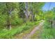 Scenic view of a natural area with a stream, trees, and a pathway, providing a tranquil outdoor space at 1715 Alkire St, Golden, CO 80401