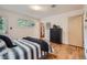 Bedroom with hardwood floors, light walls, and views into the hallway at 1715 Alkire St, Golden, CO 80401